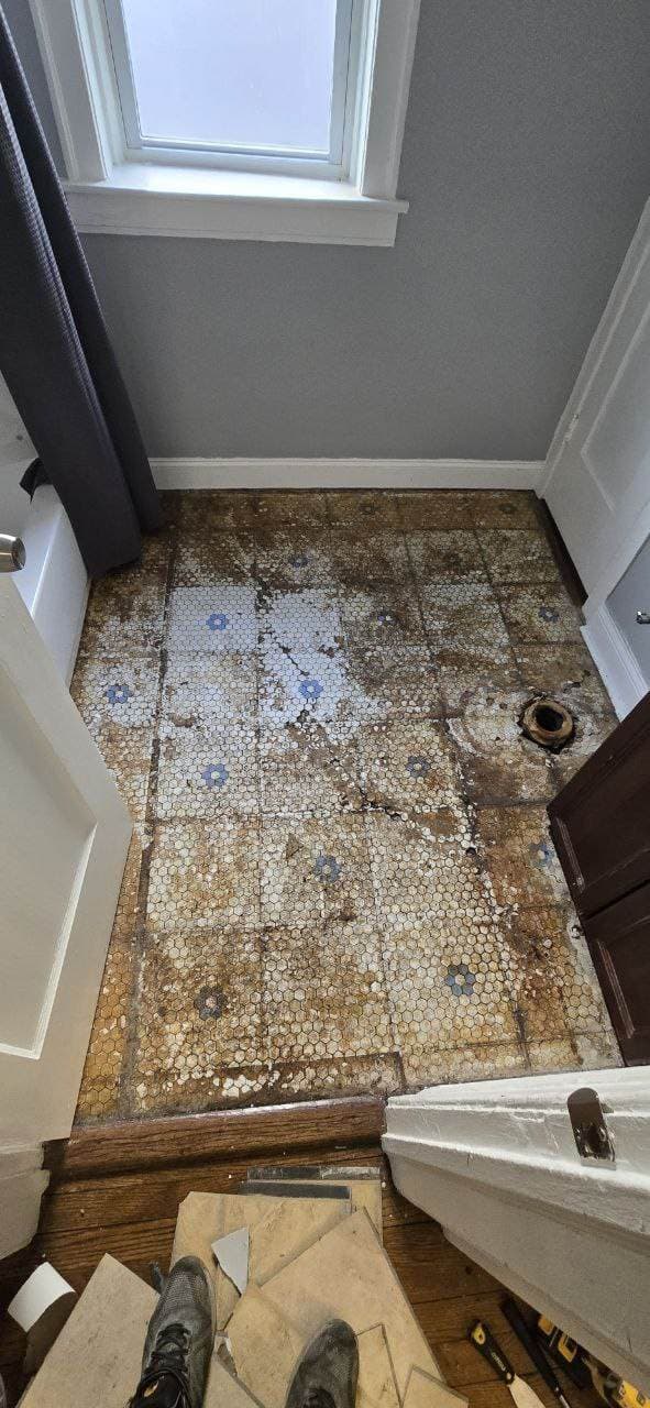 Bathroom floor tile removal before remodeling and new tile installation by BAX