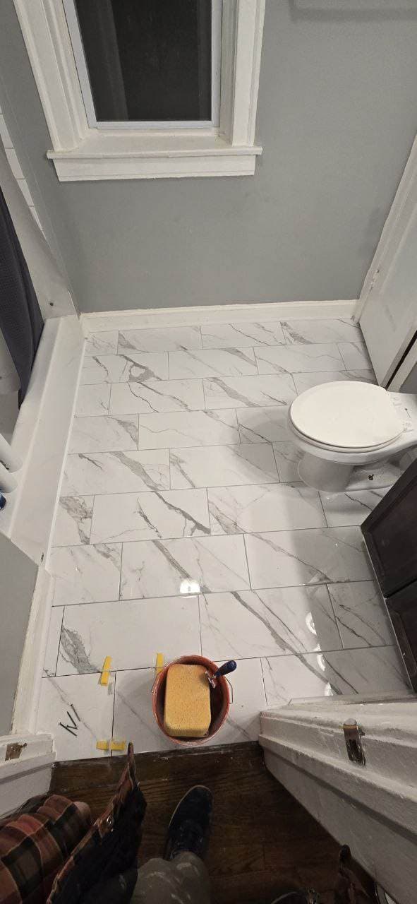 Marble-look bathroom floor tile installation completed by BAX in Hoffman Estates