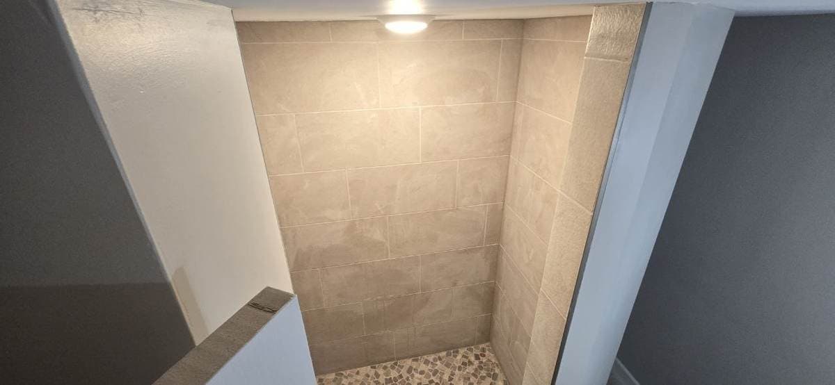 Walk-in shower tile remodel with wall tile and shower floor completed by BAX