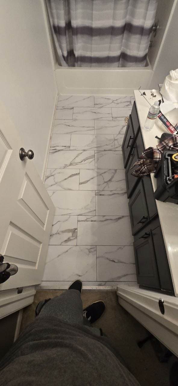 White marble-look bathroom floor tile installation completed by BAX
