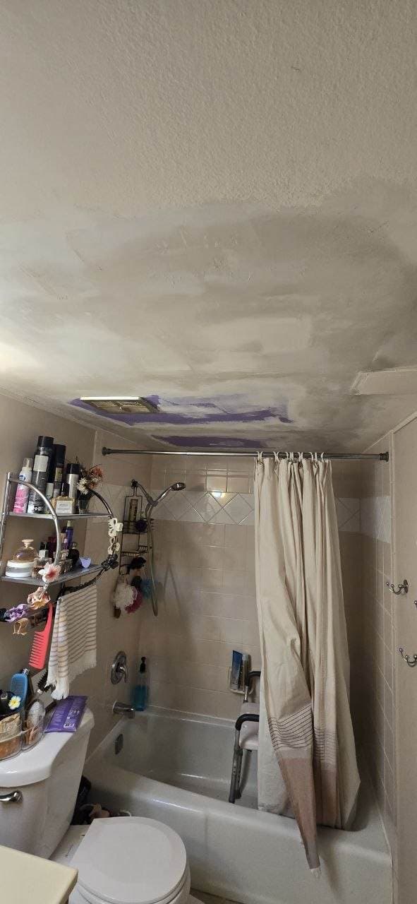 Bathroom ceiling drywall patching in progress over a shower area by BAX