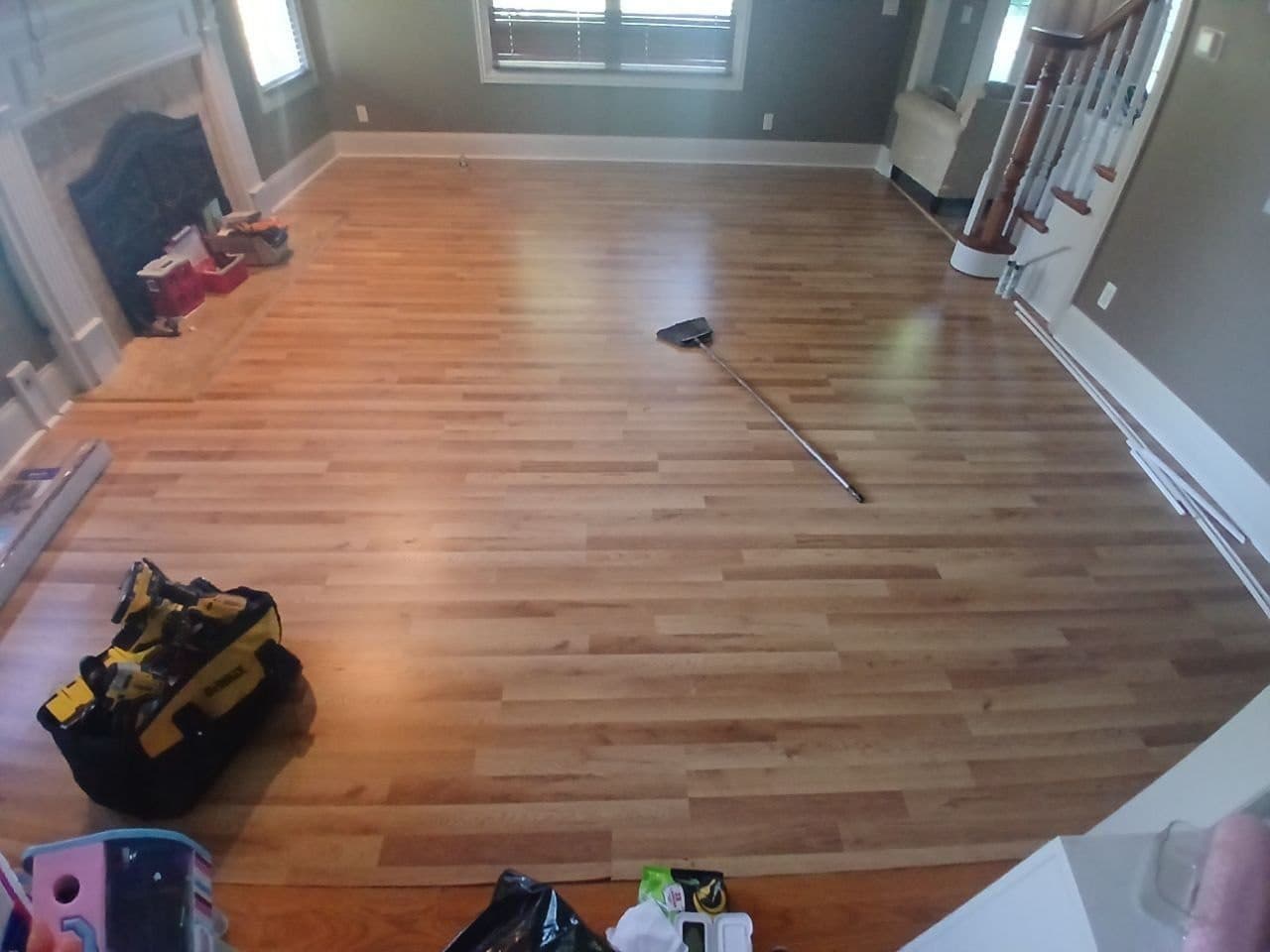 Finished laminate plank flooring installation in a Hoffman Estates living room by BAX